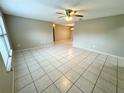 Spacious living room with tile floors and ceiling fan at 7817 Satsuma Ct, Orlando, FL 32835