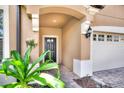 Front entrance with a dark door and brick walkway at 8804 Macapa Dr, Kissimmee, FL 34747