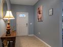 Light and airy entryway with tile floor and artwork at 8804 Macapa Dr, Kissimmee, FL 34747