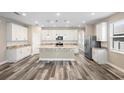 Open concept kitchen with island, stainless steel appliances, and white cabinets at 1012 S Holly Ave, Sanford, FL 32771
