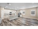 Modern kitchen with white cabinets, granite countertops, and wood-look floors at 1012 S Holly Ave, Sanford, FL 32771