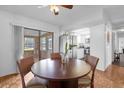 Bright dining area with wood flooring and a view into the kitchen at 354 Park Dr, Deland, FL 32724