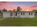Single story home with a white exterior and attached garage at 354 Park Dr, Deland, FL 32724