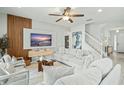 Open living room with comfortable seating and large TV at 5229 Oakbourne Ave, Davenport, FL 33837