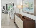Bright entryway with stylish console table and view to living room at 5229 Oakbourne Ave, Davenport, FL 33837