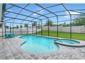 Screened pool and spa with lounge chairs at 10472 Petrillo Way, Winter Garden, FL 34787