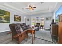 Spacious living room featuring hardwood floors, a cozy seating area, and access to the backyard at 10472 Petrillo Way, Winter Garden, FL 34787