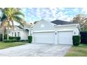 Beautiful home with a three-car garage and lush landscaping at 7567 Brightwater Pl, Oviedo, FL 32765