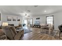 Open living and dining area with wood-look floors, and sliding glass door at 2716 Fieldbrooke Way, Edgewater, FL 32141