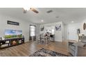 Open living and dining area with wood-look floors and access to kitchen at 2716 Fieldbrooke Way, Edgewater, FL 32141