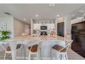 Modern kitchen with white cabinets, granite countertops, and kitchen island with seating at 1475 Haines Dr, Winter Haven, FL 33881