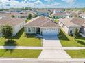 Aerial view of a single-story house with a solar panel system and a two-car garage at 1475 Haines Dr, Winter Haven, FL 33881