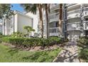Condo building with a walkway, landscaping and palm trees at 13905 Fairway Island Dr # 1022, Orlando, FL 32837