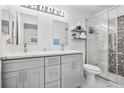 Updated bathroom with double vanity, marble flooring, and a glass shower at 13905 Fairway Island Dr # 1022, Orlando, FL 32837