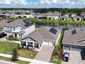 House with solar panels, a large backyard, and a lake view at 5013 Center Ct, Saint Cloud, FL 34772