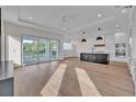 Open concept kitchen and living area with hardwood floors and sliding glass doors at 1917 S Lakemont Ave, Winter Park, FL 32792