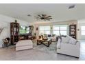 Spacious living room with comfortable seating, large windows and a ceiling fan at 25 Bahia Crse, Ocala, FL 34472