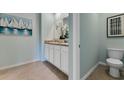 Main bathroom with double sinks, toilet, and a light and airy feel at 2892 Waterlily Way, Poinciana, FL 34759