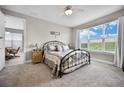 Bright bedroom with a metal bed frame and large window at 919 Braewood Dr, Clermont, FL 34715