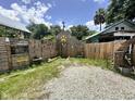 Gravel backyard with wooden fence and gate at 195 Railroad Ave, Osteen, FL 32764