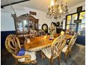 Elegant dining room with a large wooden table and chandelier at 195 Railroad Ave, Osteen, FL 32764