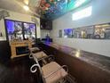 Long bar with seating and a decorative fireplace at 195 Railroad Ave, Osteen, FL 32764