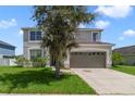 Two-story house with a two-car garage and a green lawn at 2839 Boating Blvd, Kissimmee, FL 34746