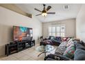 Bright living room featuring a large sectional sofa and flat-screen TV at 3090 Tioga Ter, Deltona, FL 32738