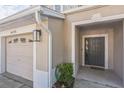 Townhouse exterior with gray door and attached garage at 14175 Turning Leaf Dr, Orlando, FL 32828