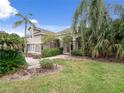 House exterior featuring a two-story home with landscaping and walkway at 25013 Derby Dr, Sorrento, FL 32776