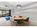 Bright dining area with light wood table and four green chairs at 6847 Sperone St, Orlando, FL 32819