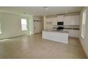 Open kitchen with island, granite countertops, and stainless steel appliances at 1999 Iorio St, Saint Cloud, FL 34771