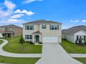 Two-story house with a two-car garage, landscaping, and a teal front door at 821 Sun Burst Rd, Winter Haven, FL 33880