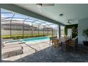 Private screened-in pool and patio with outdoor dining furniture at 3625 Lily Ln, Davenport, FL 33897