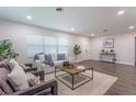 Living room with hardwood floors, neutral decor, and ample natural light at 905 Marabon Ave, Orlando, FL 32806