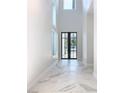 Bright entryway with marble floors and black-framed doors at 1020 Jack Nicklaus Ct, Kissimmee, FL 34747