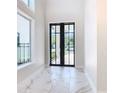 Elegant entryway with marble floors and black-framed doors at 1020 Jack Nicklaus Ct, Kissimmee, FL 34747