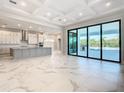 Modern kitchen with marble floors, island, and access to patio at 1020 Jack Nicklaus Ct, Kissimmee, FL 34747