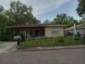 One-story house with brick driveway and fenced yard at 522 W Park St, Lakeland, FL 33803