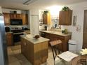 Kitchen with island, ample cabinetry, and modern appliances at 15507 Willet Ct, Mascotte, FL 34753