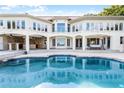 Luxury home with large pool, expansive patio, and waterfront views at 8605 Bay Shore Cv, Orlando, FL 32836