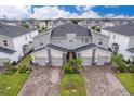 Aerial view of three-unit townhome community at 8889 Cabot Cliffs Dr # 104, Davenport, FL 33896