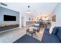 Open living room, kitchen, and dining area with modern decor at 8889 Cabot Cliffs Dr # 104, Davenport, FL 33896