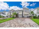 Modern three-unit townhome with driveway and landscaping at 8889 Cabot Cliffs Dr # 104, Davenport, FL 33896