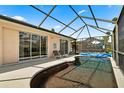 Relaxing pool area with a screened enclosure and patio furniture at 2907 Sunset Lakes Blvd, Kissimmee, FL 34747