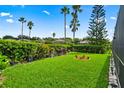Landscaped backyard with lush greenery and a circular garden at 2907 Sunset Lakes Blvd, Kissimmee, FL 34747