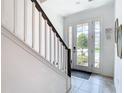 Bright entryway with staircase and view to backyard at 8976 Amelia Downs Trl, Kissimmee, FL 34747