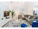 Open living room with sectional sofa and stylish decor at 8976 Amelia Downs Trl, Kissimmee, FL 34747