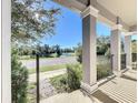 Covered porch with view of a tranquil pond and landscape at 1429 Happy Bird Ln, Winter Springs, FL 32708