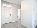 Front entry with tile floors and interior door at 2222 Elmsford Pt, Sanford, FL 32771